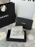 Chanel small silver quilted flap bag with chain strap, front logo medallion.