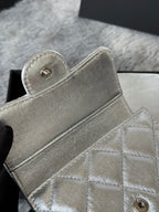 Small bag in metallic silver with snap-button flap and quilted front detail