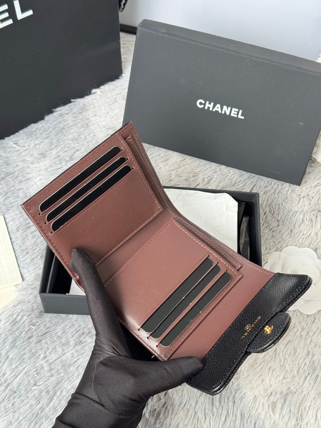 CHANEL small wallet open with brown card slots and black exterior