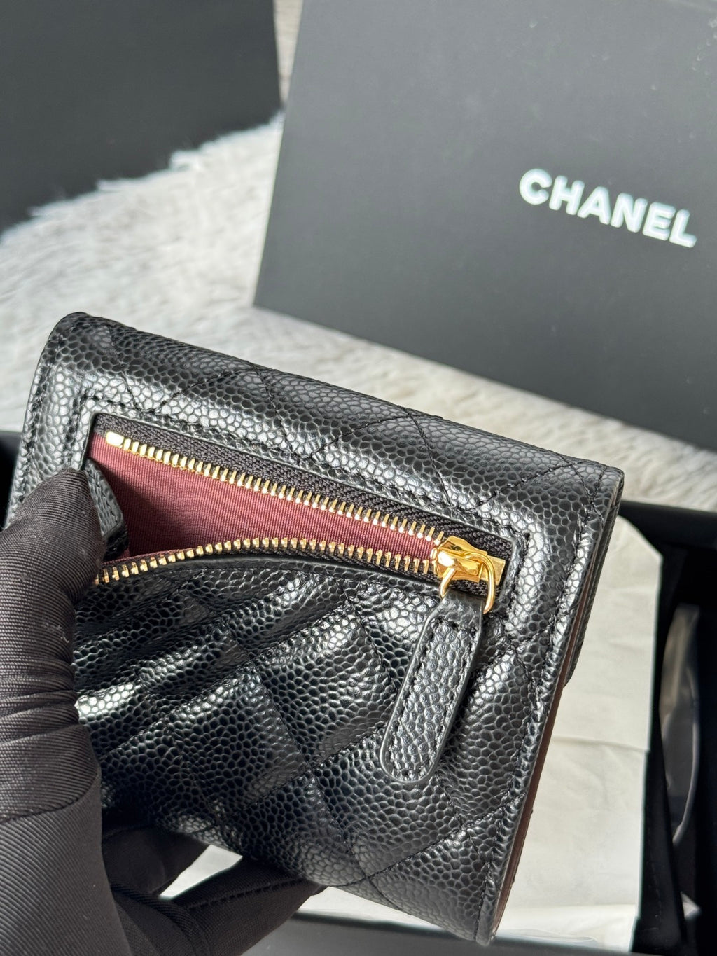 CHANEL small black quilted flap wallet open, showing gold zipper