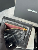 CHANEL small black quilted flap wallet open, showing gold zipper