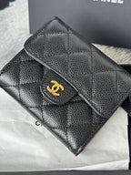 CHANEL small black embossed flap wallet with gold turn-lock logo