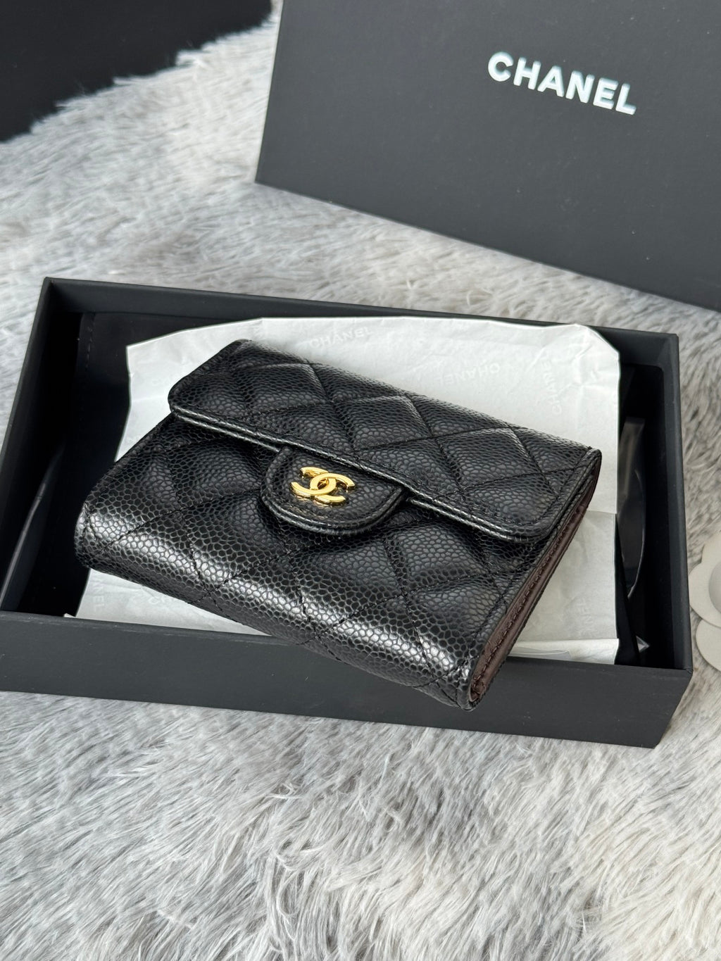 CHANEL small black textured flap wallet with round gold logo