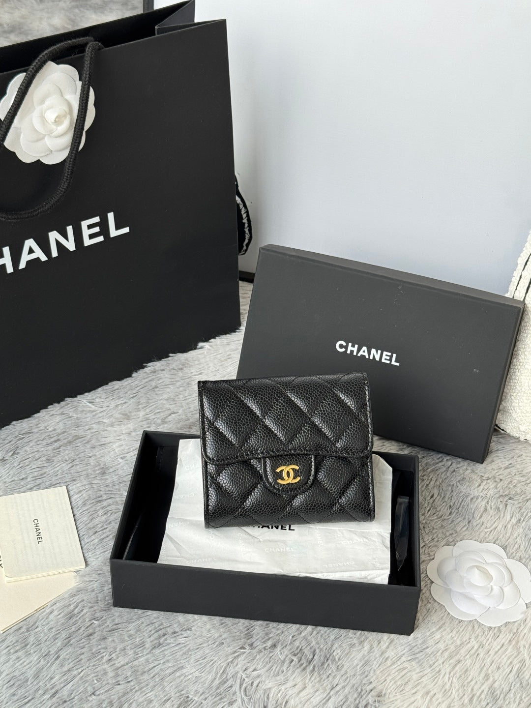 CHANEL small black quilted flap wallet with gold logo clasp