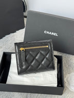 CHANEL small black quilted flap wallet with gold zipper detail