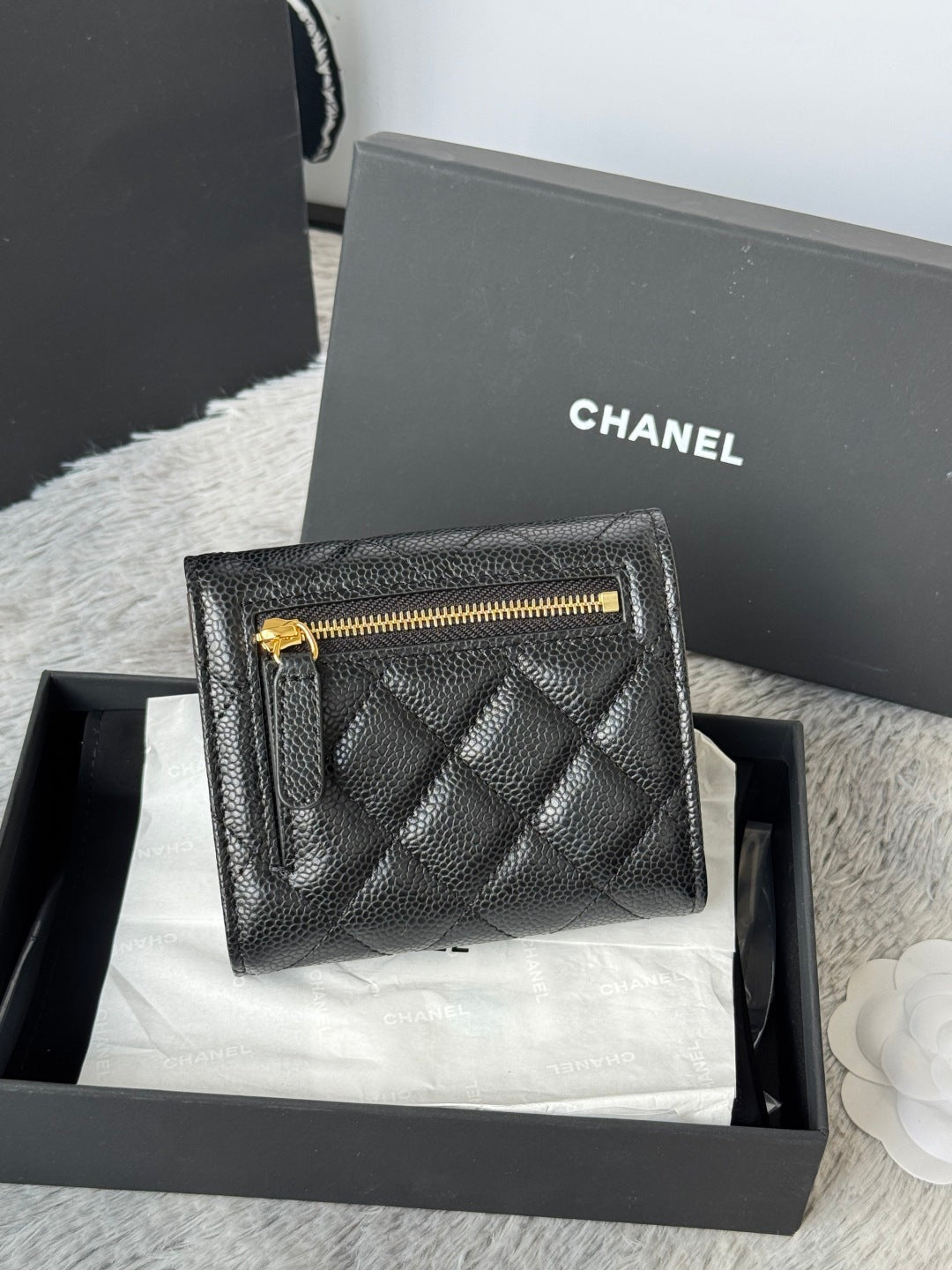 CHANEL small black quilted flap wallet with gold zipper detail