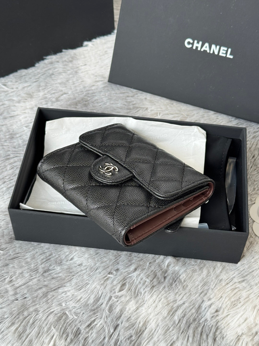Black Chanel leather small bag with top flap and CC emblem, side view