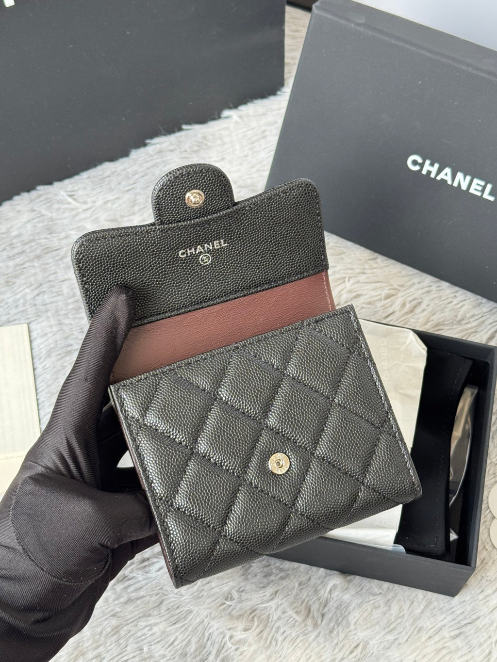 Black Chanel quilted small bag with snap closure and top handle tab