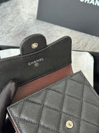 Black Chanel textured leather small bag with quilted flap front, close view