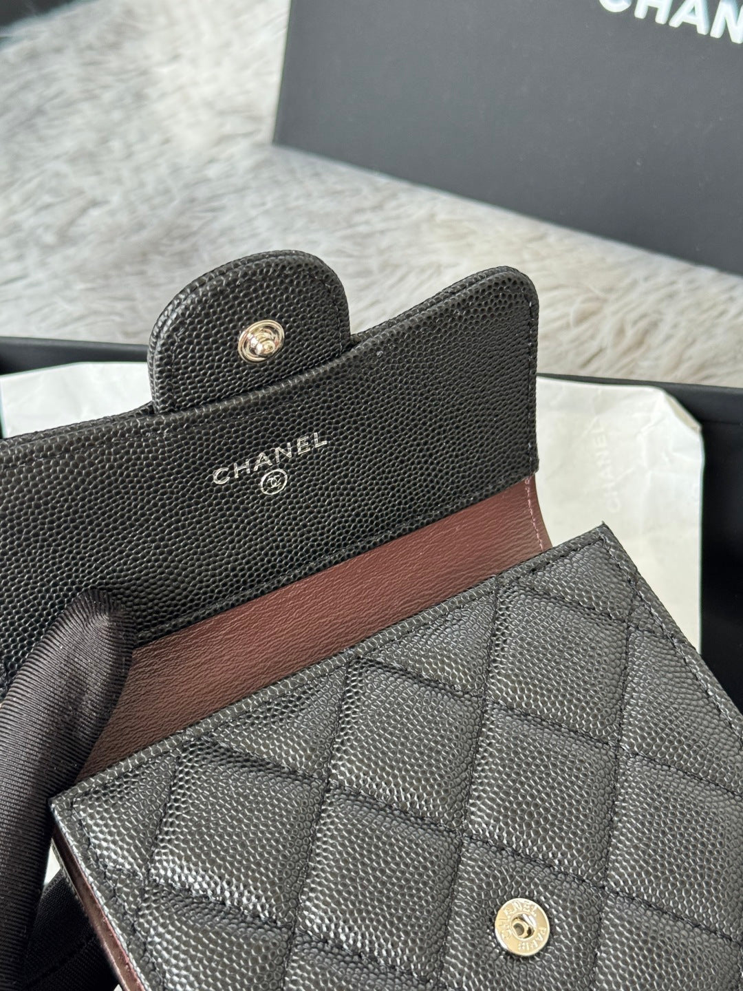 Black Chanel textured leather small bag with quilted flap front, close view