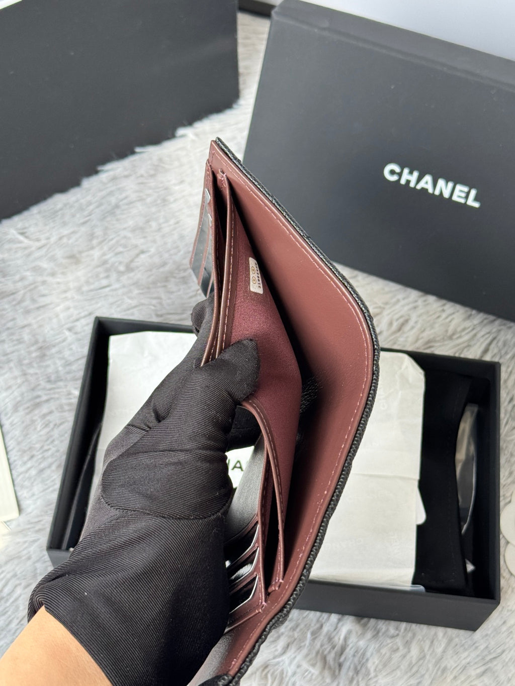 Small leather wallet, open view with slim compartments and foldover design, pinkish-brown.