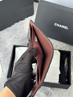 Small leather wallet, open view with slim compartments and foldover design, pinkish-brown.