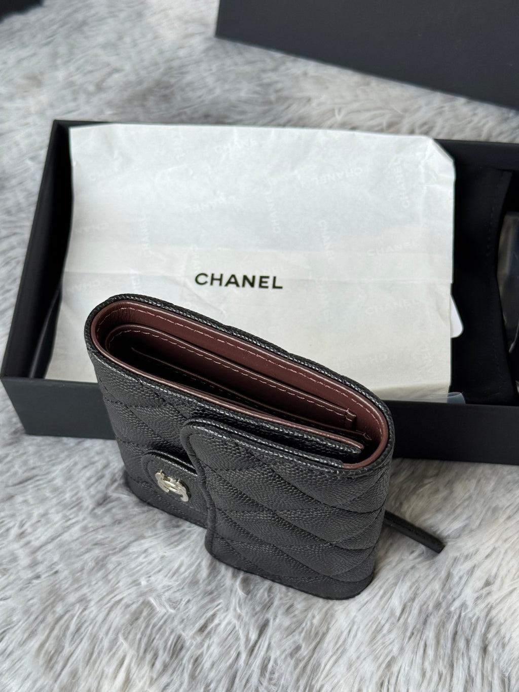 Black Chanel quilted leather wristlet with burgundy lining and strap ring