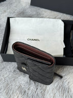 Black Chanel quilted leather wristlet with burgundy lining and strap ring