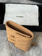 Small quilted flap bag, tan interior view with multiple card slots and Chanel