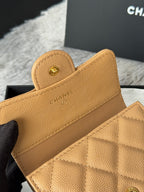 Small quilted flap bag close-up, tan leather with card-slot lining and Chanel