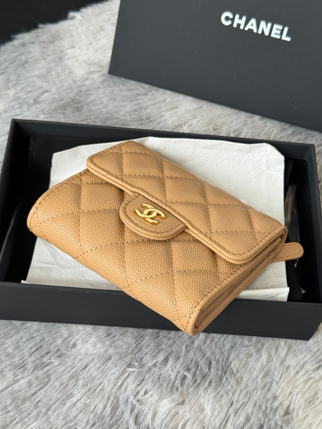 Small quilted flap bag, tan leather with chain strap and Chanel emblem