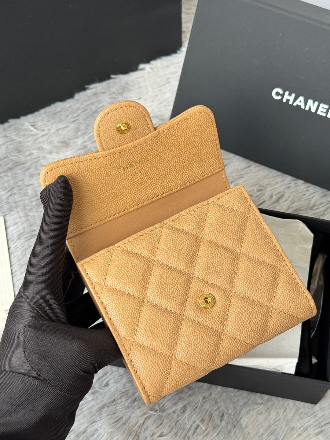 Small quilted flap card bag, tan leather with Chanel emblem and snap pocket