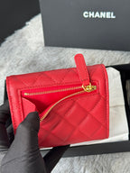Red quilted small bag with zip opening and gold double-C logo on front