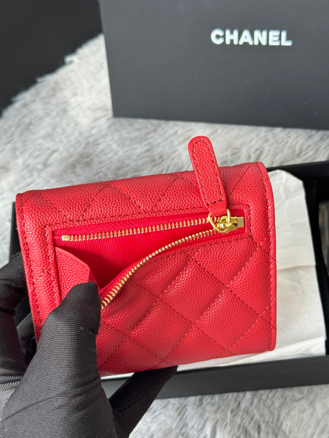 Red quilted small bag with zip opening and gold double-C logo on front
