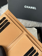 Tan leather small bag with front panel and black metal bar details, CHANEL logo