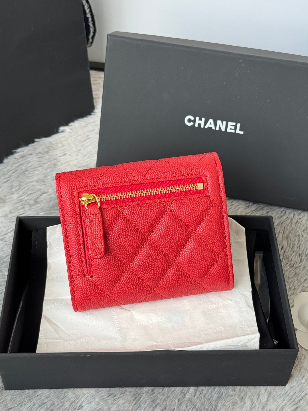 Red quilted small bag with front zip pocket and gold double-C logo