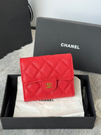 Red quilted small bag with front flap and gold double-C logo, snap closure