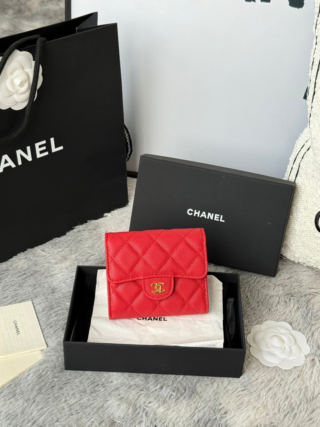 Red quilted small bag with front flap and gold double-C logo, short strap attached