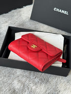 Red quilted small bag with wrist strap, front flap with gold double-C logo