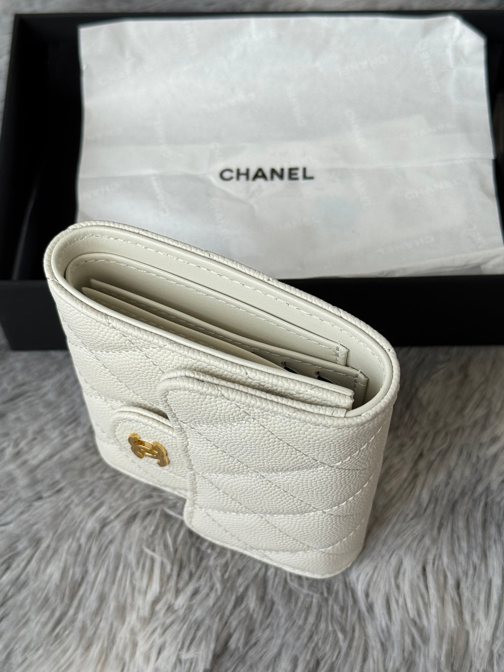 Off-white quilted mini bag open view showing compartments and stitching.