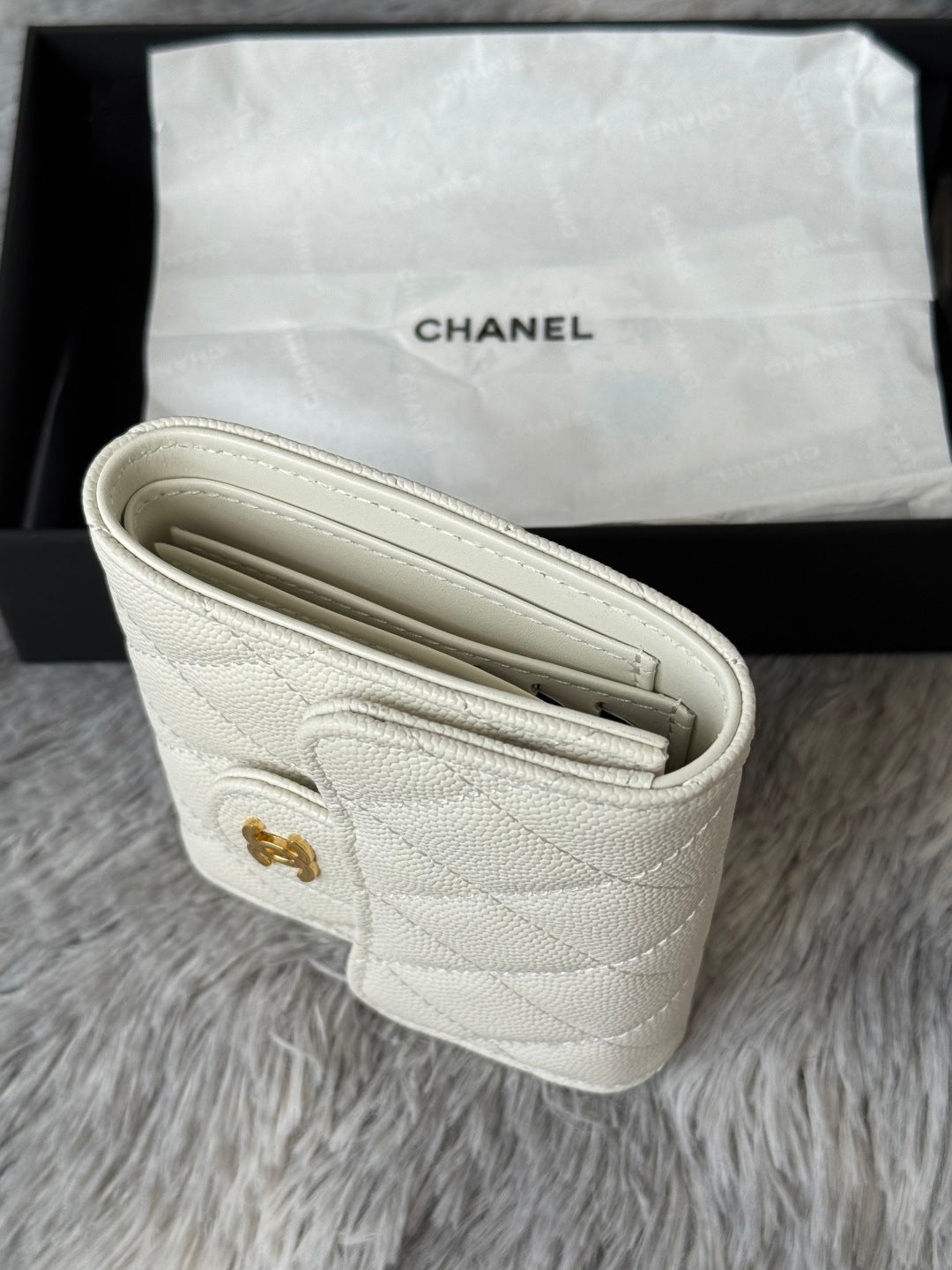 Off-white quilted mini bag open view showing compartments and stitching.