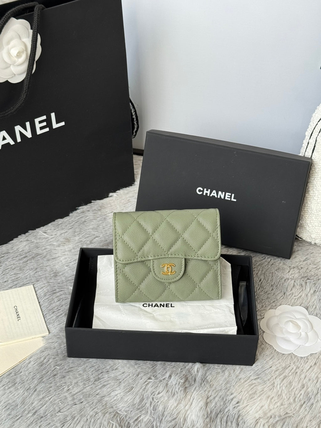 Small quilted leather flap bag in light green with CHANEL logo clasp