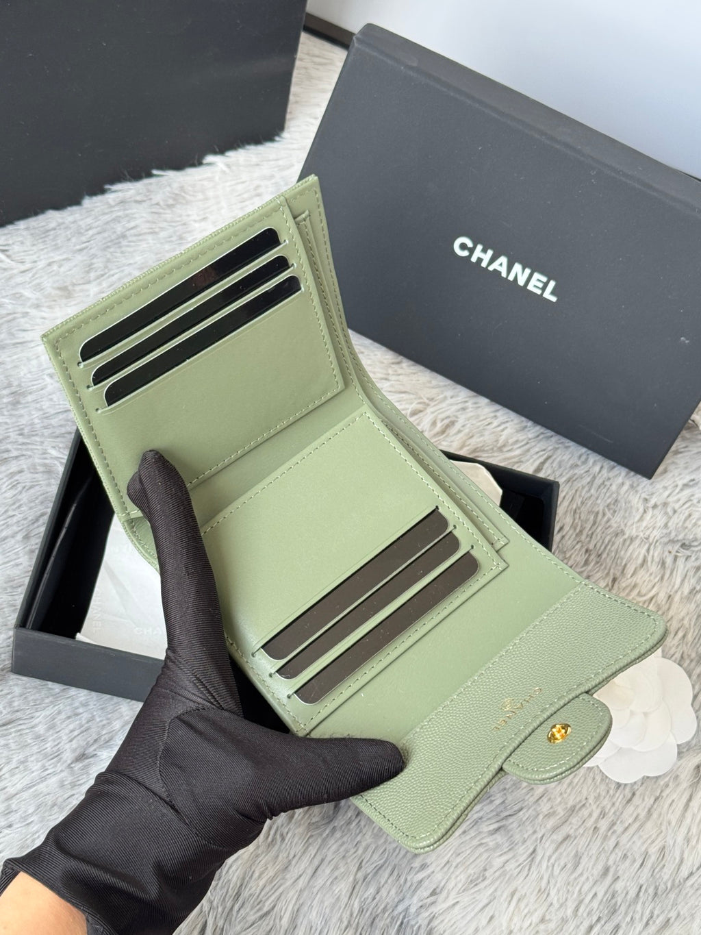 Small light green wallet-style pouch with card slots and gold-tone CHANEL hardware