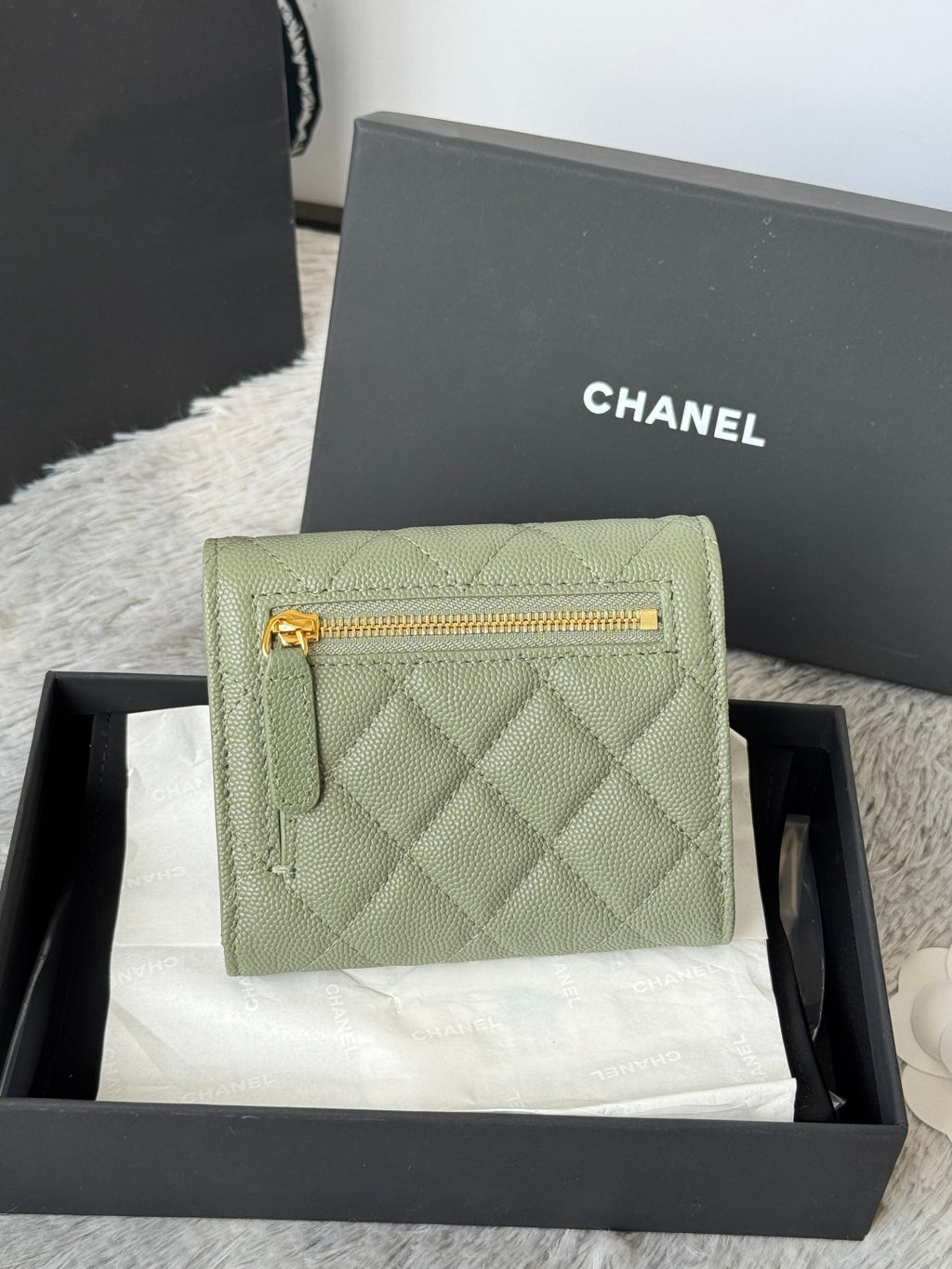 Small quilted leather bag in light green with gold zip and CHANEL logo
