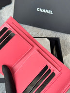 Small pink Chanel bag with black-striped card slots and stitched front