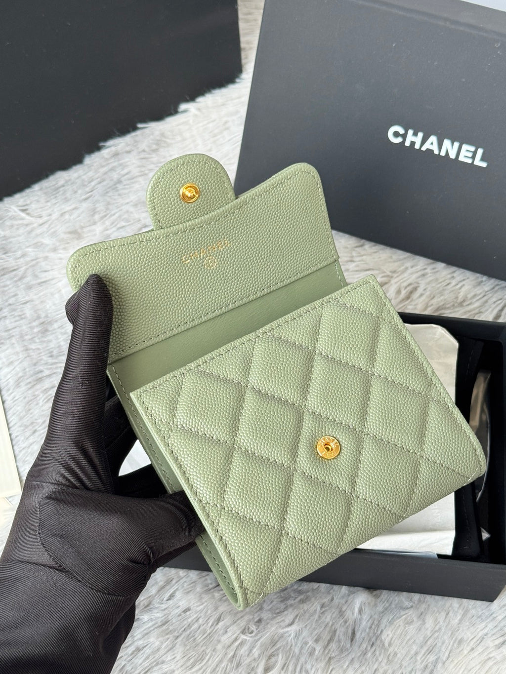 Small light green quilted mini bag with flap and gold-tone button closure