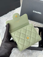 Small light green quilted mini bag with flap and gold-tone button closure