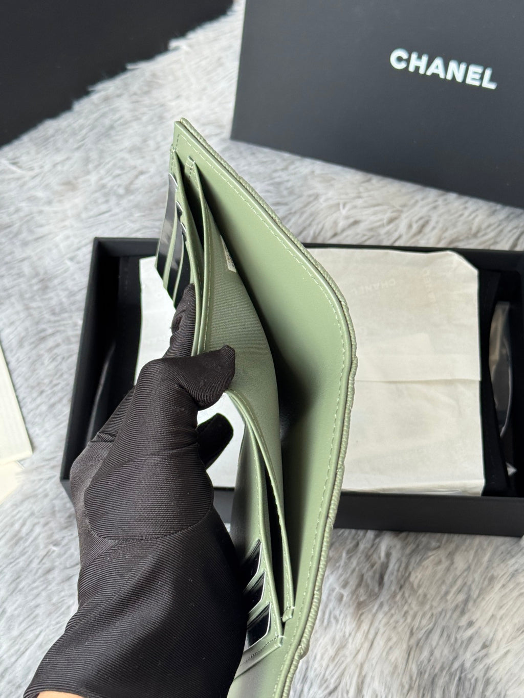 Light green small bag with structured sides and open top flap