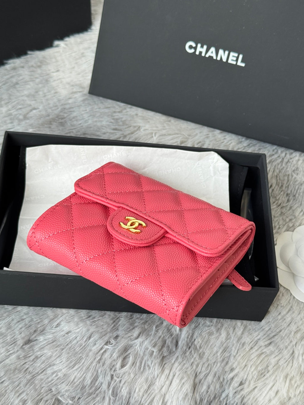 Pink quilted flap bag with gold CC emblem and short wrist strap, gift box view