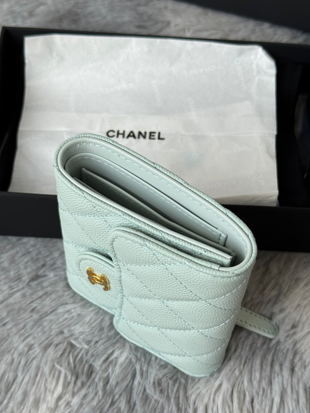 Mint quilted leather small bag interior view with slim slip pocket