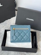 Small bag in light blue quilted leather with gold zipper and CHANEL logo patch