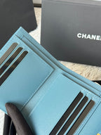 Light blue small bag with card slots and stitched flap edge