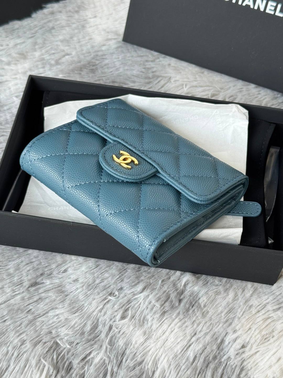 Small bag in light blue textured leather with CHANEL logo turn-lock and flap