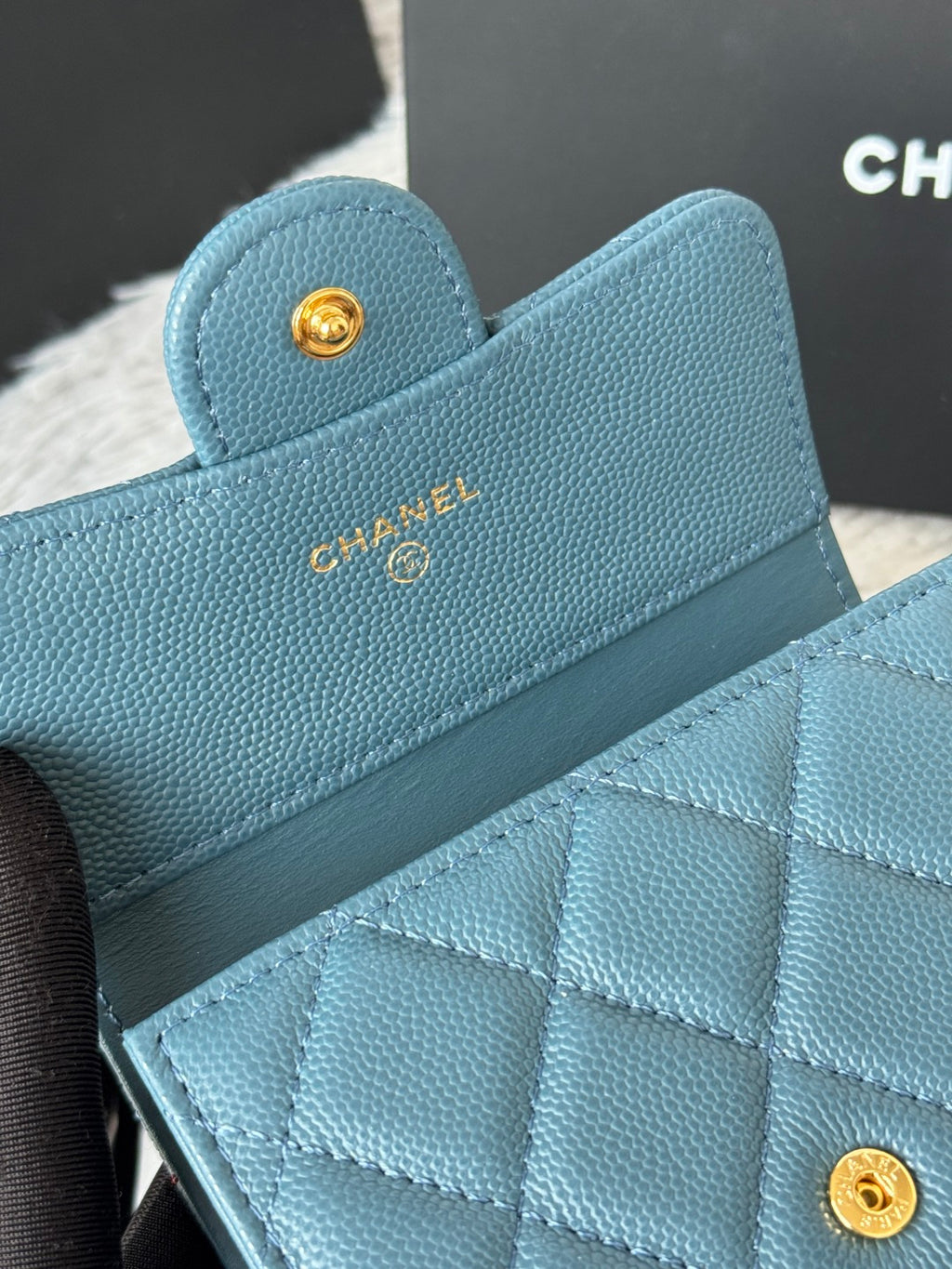 Small bag in light blue textured leather with CHANEL logo and quilted flap