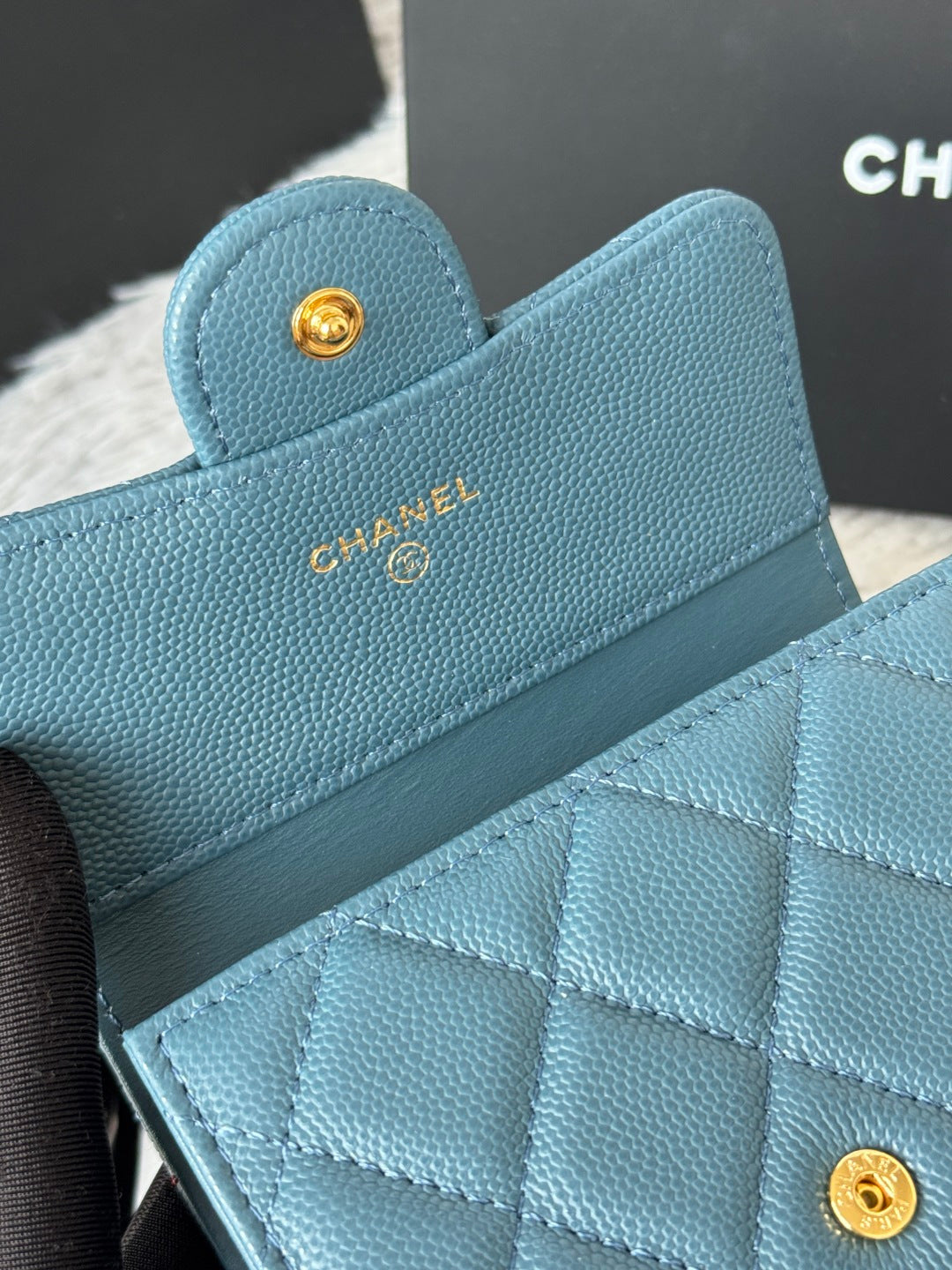 Small bag in light blue textured leather with CHANEL logo and quilted flap