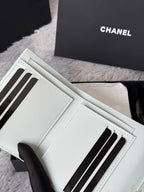 Light green small bag wallet with multiple card slots and black stripe detailing