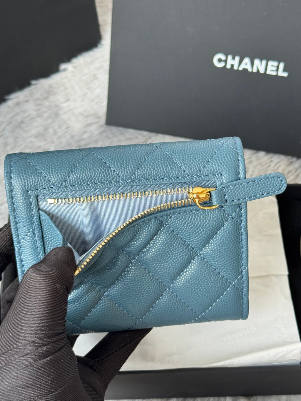 Small bag in light blue quilted leather with CHANEL gold-tone zipper pull