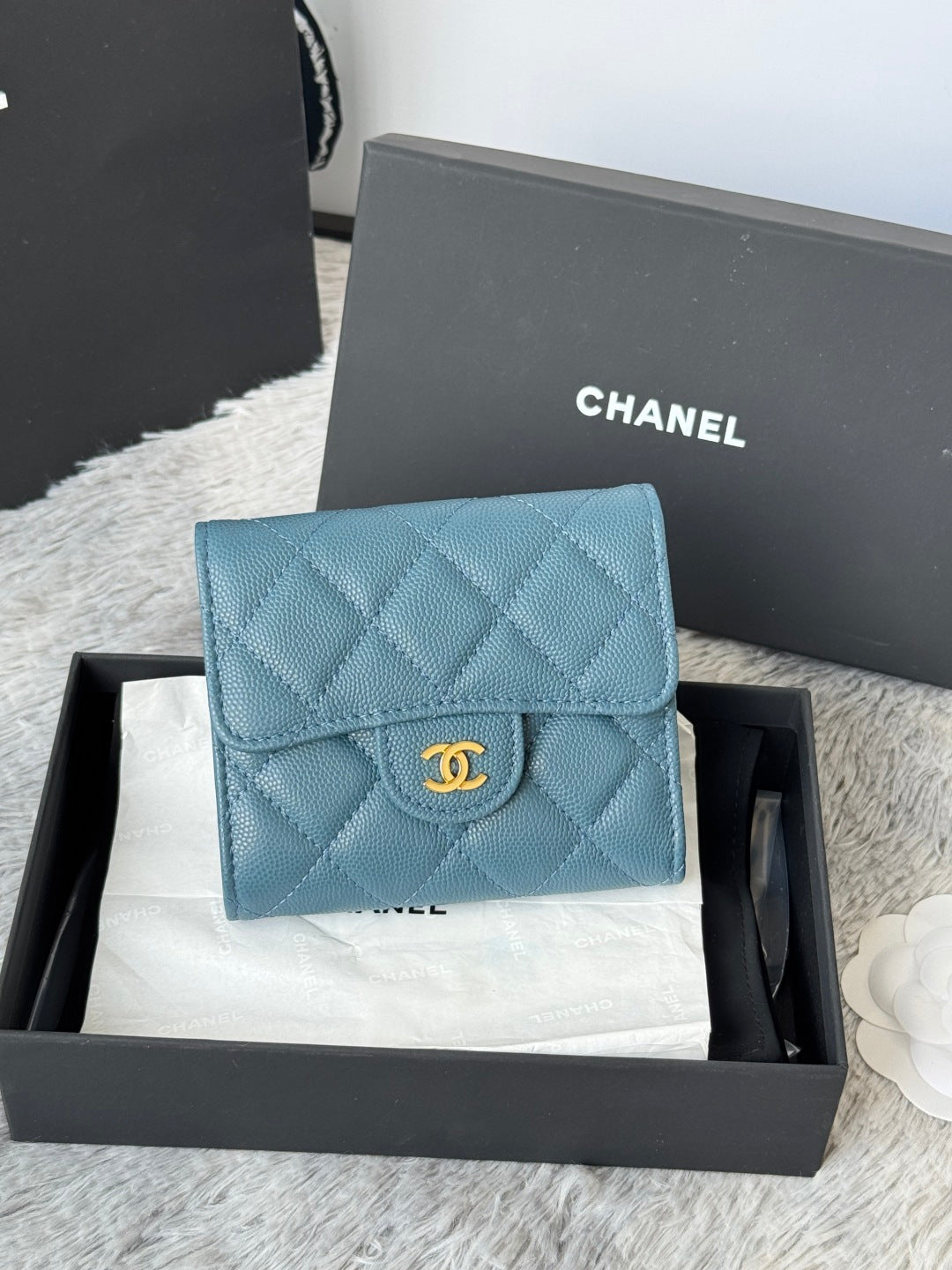 Small bag in light blue quilted leather with CHANEL logo on flap and gold-tone clasp