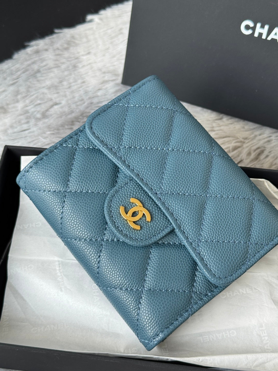 Small bag in light blue quilted leather with CHANEL logo emblem on flap
