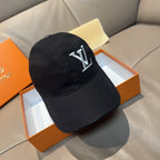 Black Louis Vuitton baseball cap with LV monogram on front, curved brim.